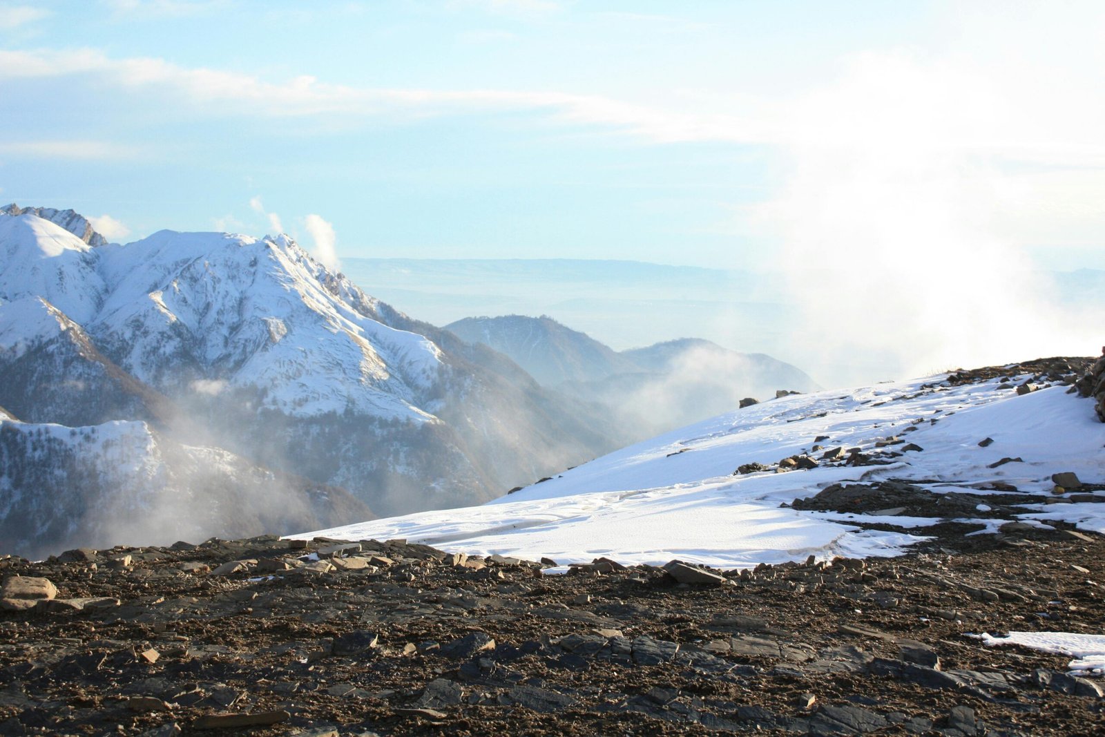 Breathtaking view of snow-covered mountains and clear sky creating a serene winter landscape.