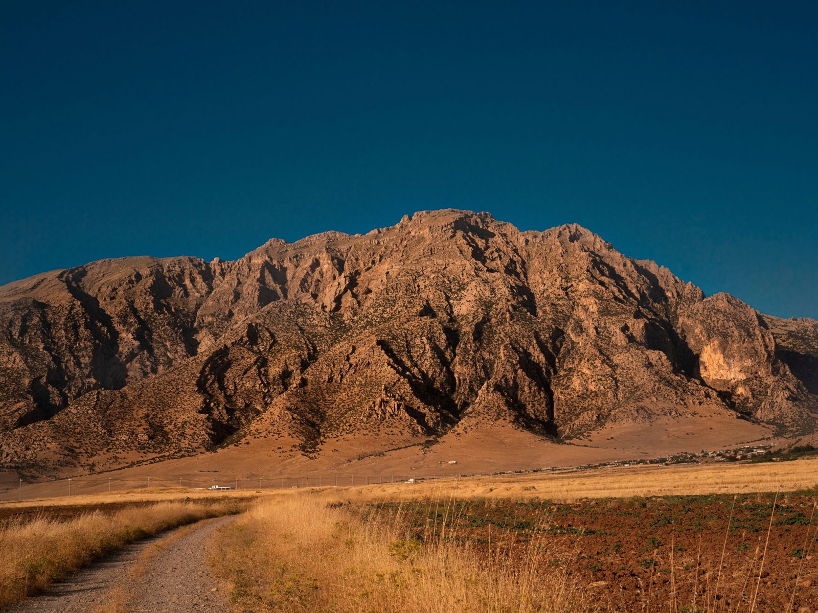 Explore the rugged beauty of Duhok's mountain landscape at sunset, a serene natural setting in Iraq.